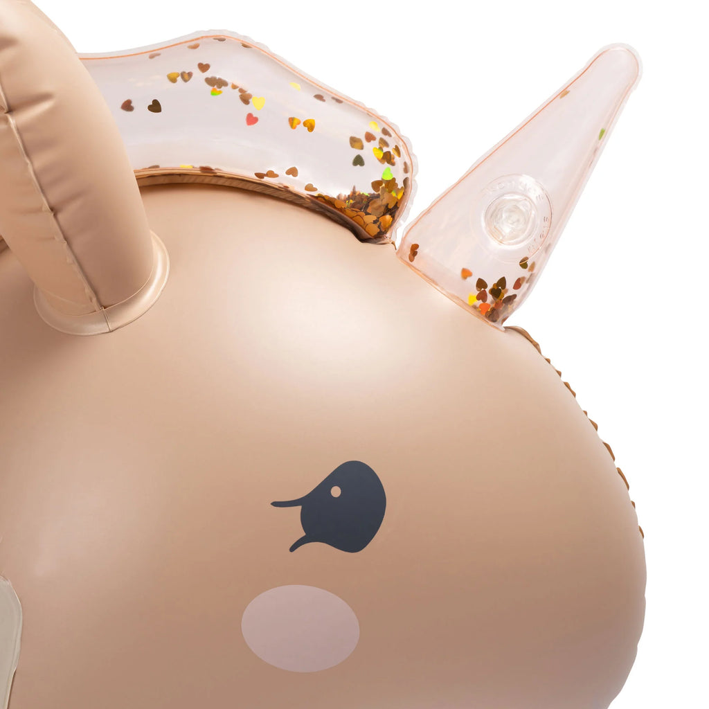 Close-up of a durable golden Inflatable Water Splasher Float - Unicorn designed like a whale, featuring a clear blowhole with gold sparkles inside.