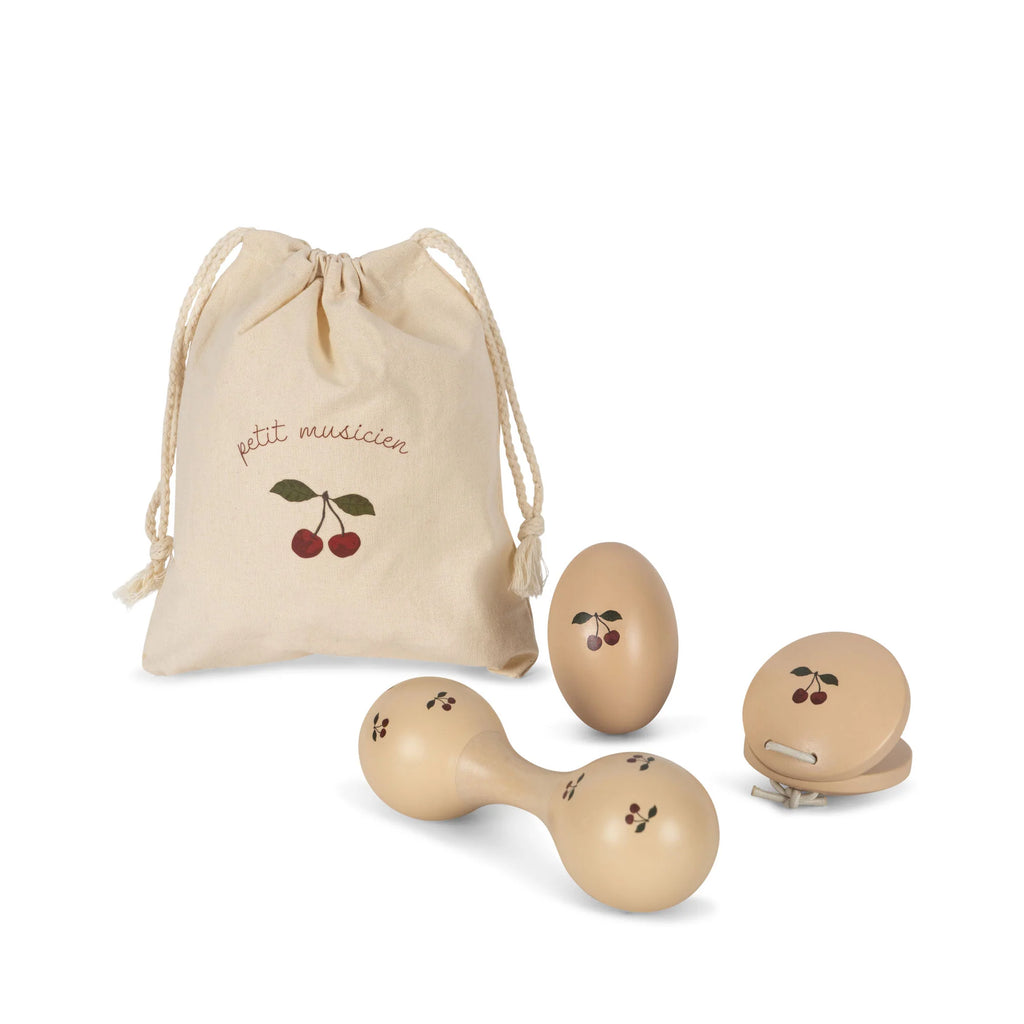 A set of Konges Sløjd Wooden Music Set - Cherry including two egg shakers and a castanet, accompanied by a drawstring bag with "tiny musicians" and cherry graphics, isolated on a white background.