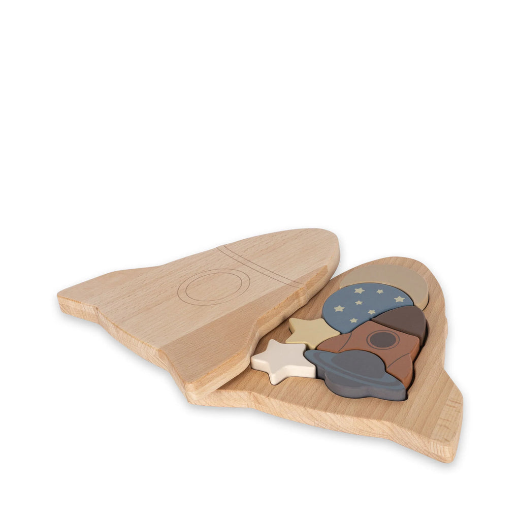 Wooden Puzzle - Rocket in the shape of a rocket, with pieces featuring stars and patterns, made from FSC-certified wood, set against a white background.