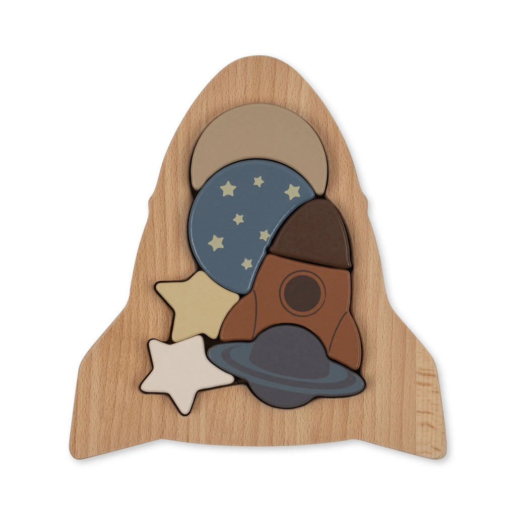 Wooden Puzzle - Rocket in the shape of a rocket launch, featuring pieces with various patterns like stars and planets, made from FSC-certified wood, set against a plain background.