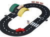 The WaytoPlay: Small Flexible Toy Road Set - Ringroad includes a set of black flexible track pieces, two colorful bridges (one green and one yellow), wooden traffic signs, and two toy cars—one in red and one in natural wood finish—arranged on the tracks for limitless imaginative play.