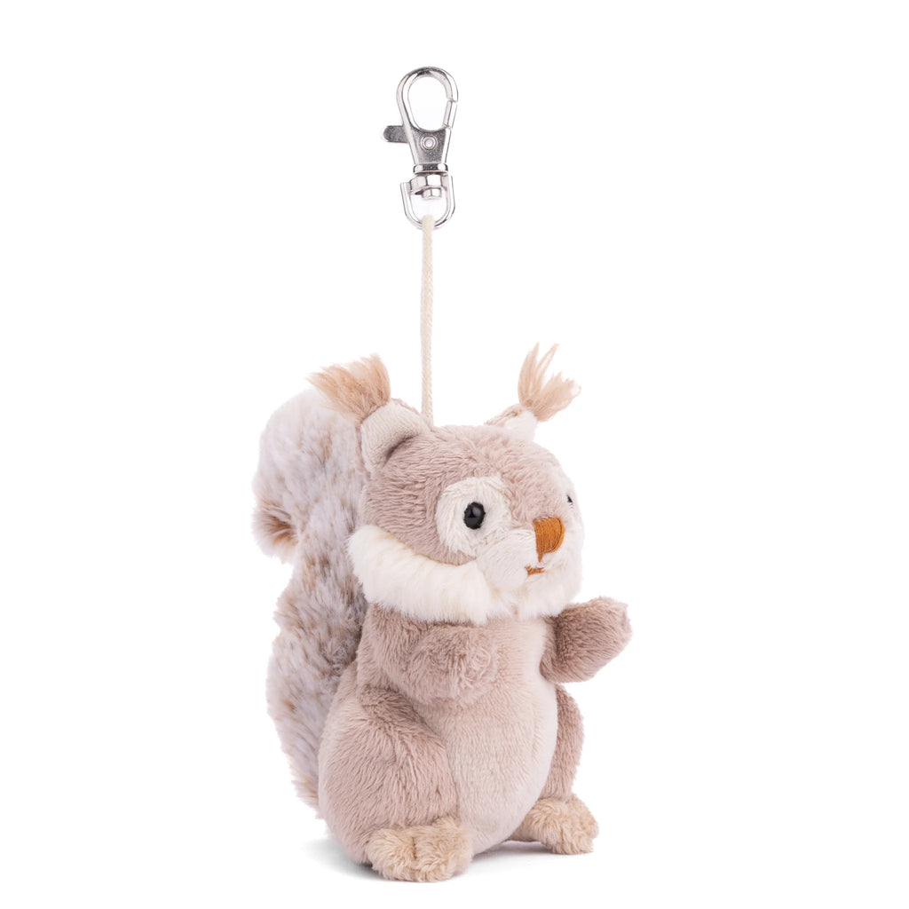Featuring soft brown and white fur, a fluffy upright tail, and a silver clasp attached to its head by a string, the Bukowski - Wiggles Squirrel Bag Charm is an adorable plush keychain that makes an enchanting woodland accessory for any bag.