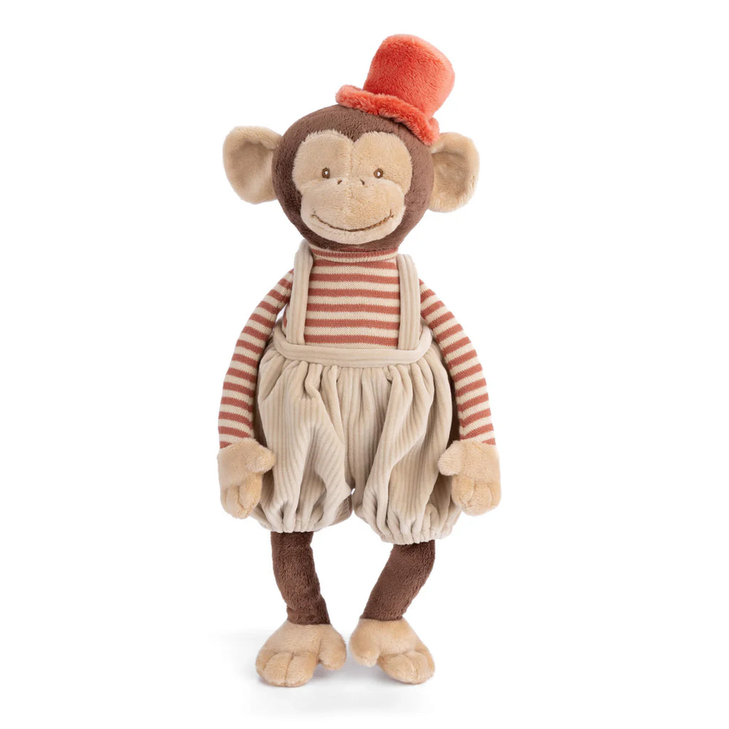 Bukowski - Winston Monkey - Tan is a plush toy featuring beige corduroy overalls, a red and beige striped shirt, and an orange top hat. The monkey stands upright with a friendly smile.