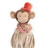 Bukowski - Winston Monkey - Tan is a plush toy featuring a striped red and beige shirt, beige puffy pants, and a bright orange top hat, smiling with crossed arms.