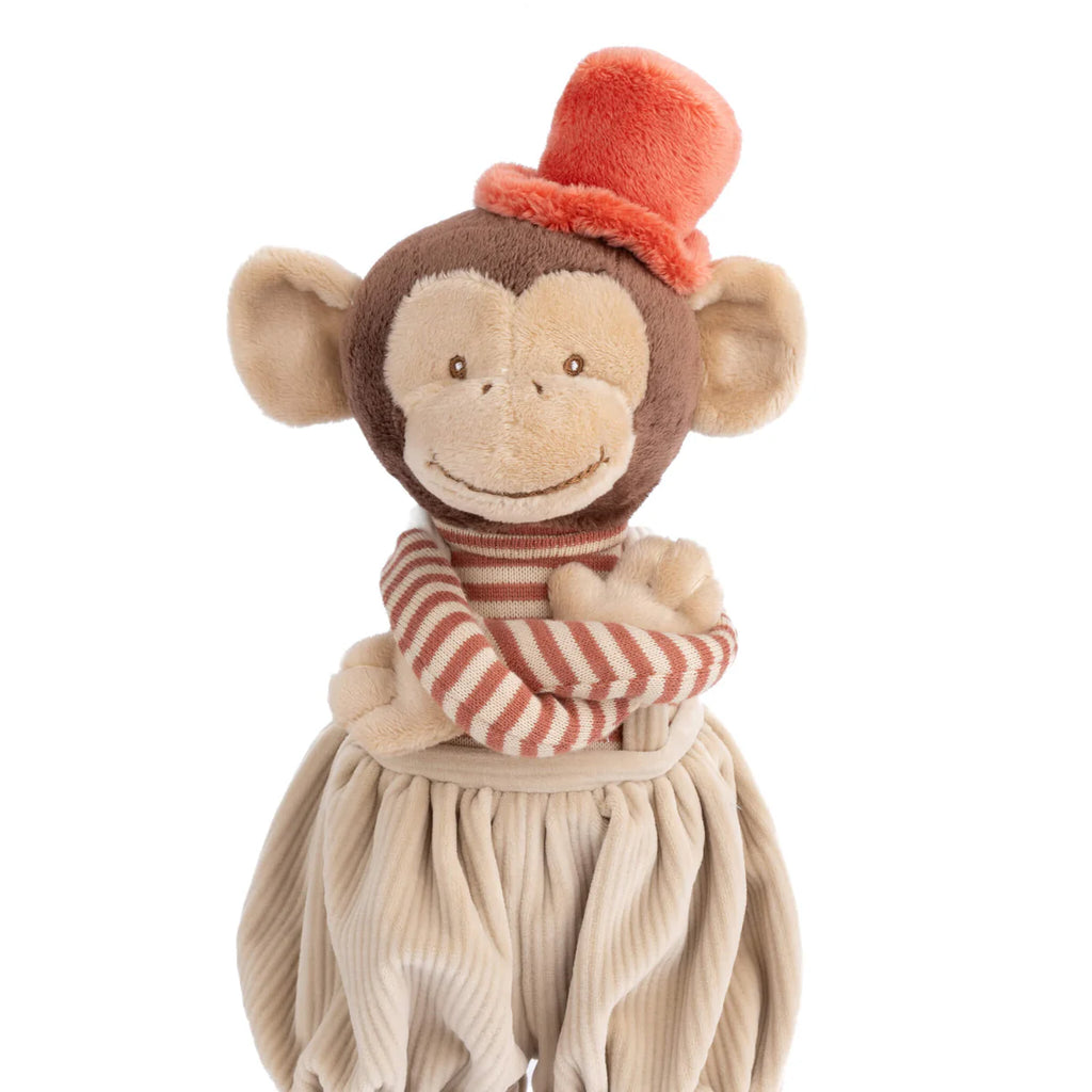 Bukowski - Winston Monkey - Tan is a plush toy featuring a striped red and beige shirt, beige puffy pants, and a bright orange top hat, smiling with crossed arms.