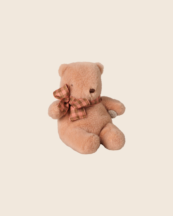 The PRE-ORDER: Maileg Teddy Bear Plush, Mini - Vintage Rose (Estimated Arrival Early October) features soft, plush fur and a plaid bow, sitting upright against a beige background and inviting hugs.