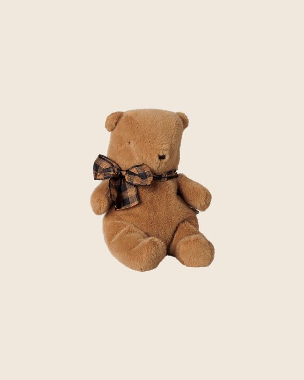 The PRE-ORDER: Maileg Teddy Bear Plush, Small - Mushroom sits upright against a light beige background, featuring soft plush fur and a large plaid bow. Estimated arrival is early October.