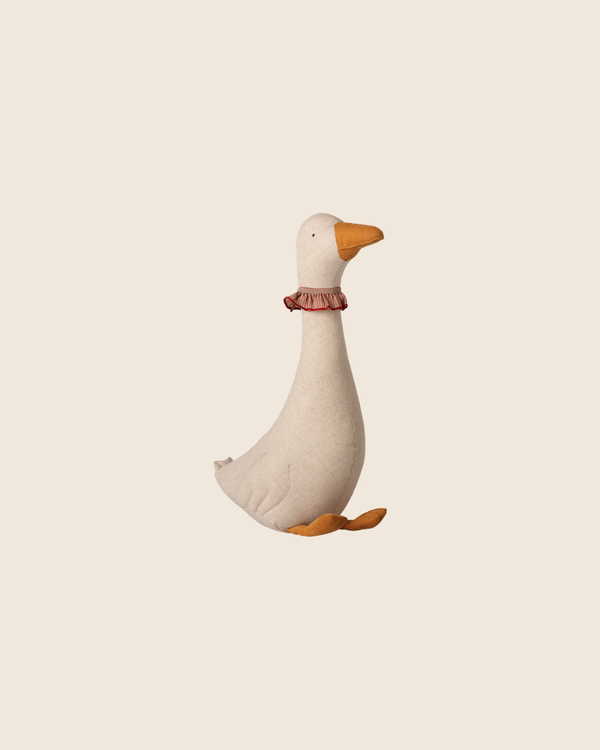 The PRE-ORDER: Maileg Goose, Small - Dark Nature (Estimated Arrival Mid September) features a plush toy goose with a white body, orange beak and feet, plus a red ruffled collar—ideal as a charming decoration or festive Christmas accent.