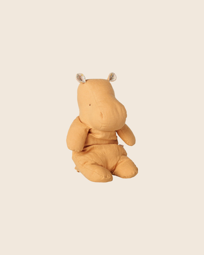 A soft, vintage yellow Maileg Safari Friends Hippo plush toy (medium, pre-order) with small round ears sits upright against a plain beige background. Estimated arrival: early November.