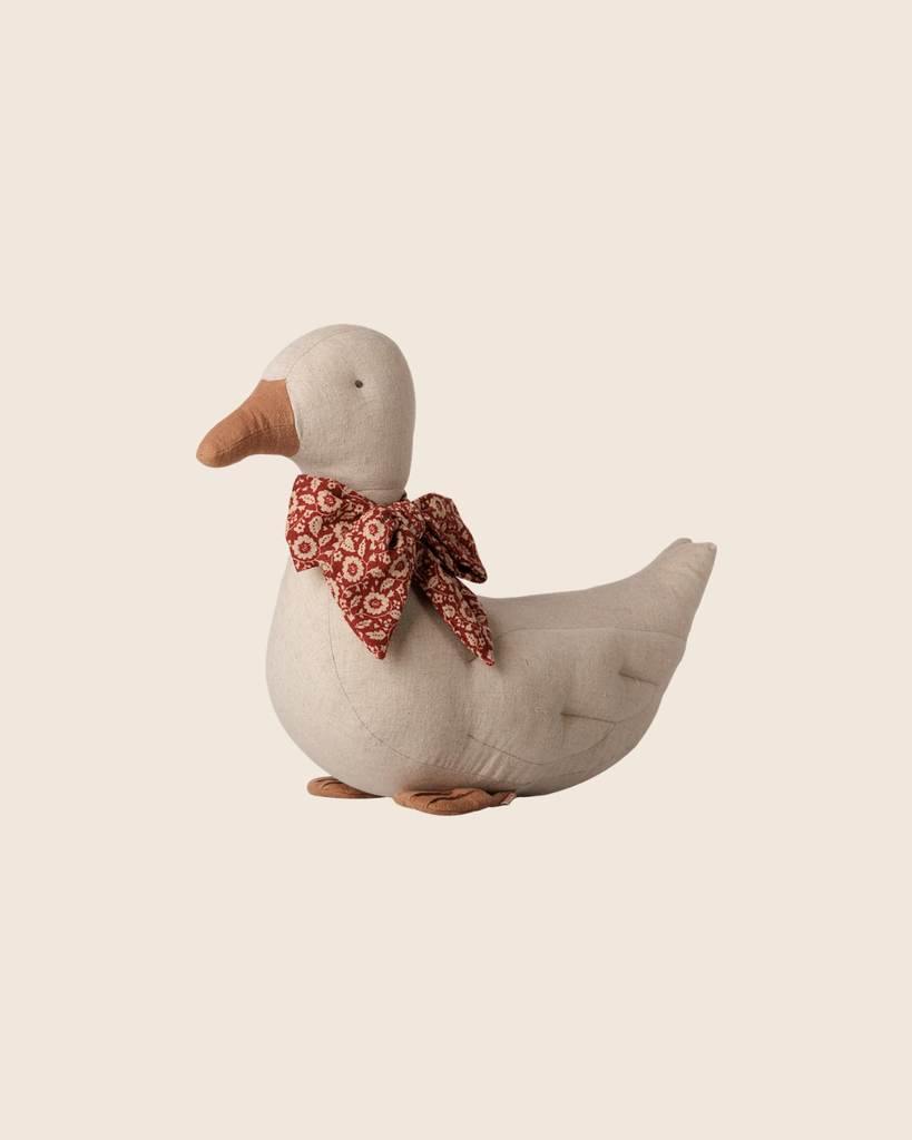 The PRE-ORDER: Maileg Duck with Bow - Sand features a soft beige plush body, orange beak and feet, and a red floral-patterned bow—an adorable Christmas decoration. Estimated arrival mid September.