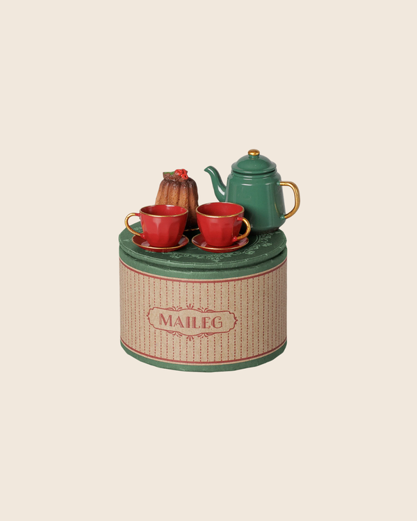 PRE-ORDER: Maileg Christmas Tea Party, Mouse - Red/Green features a green teapot, two red teacups, petite cake, and fruit tart on a striped tin—perfect for a mouse family tea set. Estimated arrival: early November.