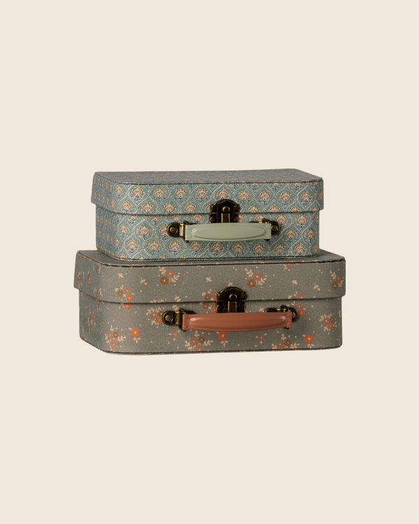 The PRE-ORDER: Maileg Suitcase Set - Michette (Estimated Arrival Early October) features two vintage-style floral suitcases, one blue with a light handle and one gray with pink, stacked together—ideal for charming, whimsical storage.