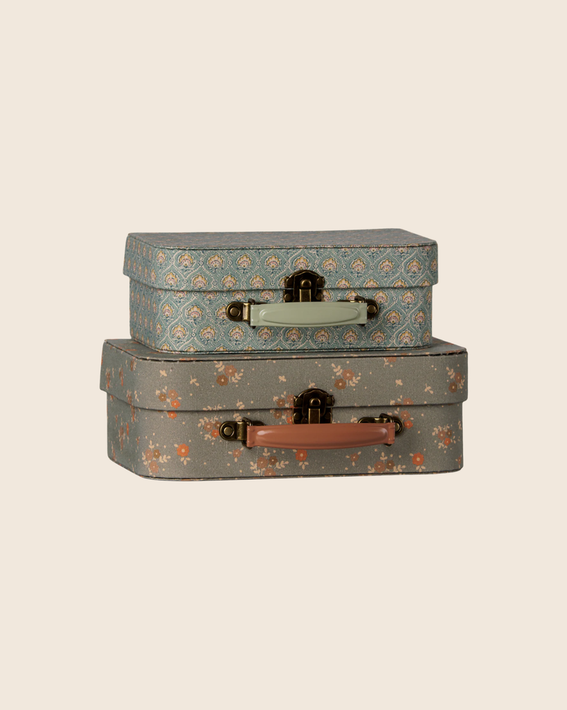 The PRE-ORDER: Maileg Suitcase Set - Michette (Estimated Arrival Early October) features two vintage-style floral suitcases, one blue with a light handle and one gray with pink, stacked together—ideal for charming, whimsical storage.