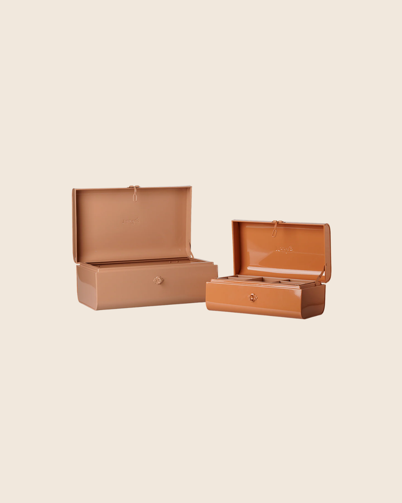 Two rectangular PRE-ORDER: Maileg Storage Suitcase Set - Powder/Coral with Tray (Estimated Arrival Early November) in different sizes are open side by side on a light beige background, showing hinged lids and small metal clasps.