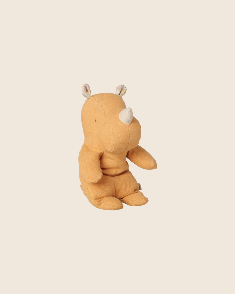 A PRE-ORDER Maileg Safari Friends Rhino plush in vintage yellow sits upright on a beige background. With embroidered eyes, patterned ears, and a white horn, this small cuddly companion arrives mid-November—perfect for cozy adventures.
