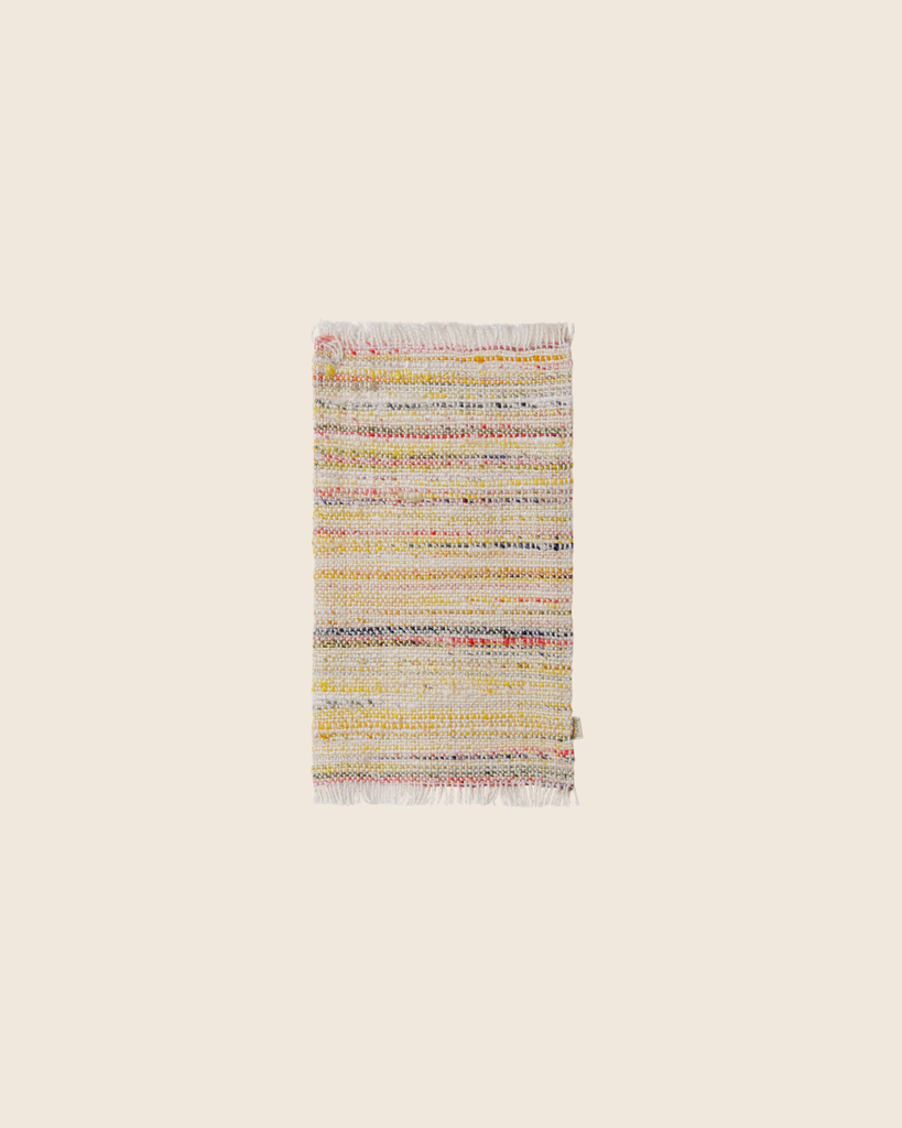 PRE-ORDER: Maileg Rug, Miniature, Large - Multi Stripe features a small rectangular design with multicolored horizontal stripes and fringed edges, shown on a plain beige background. Estimated arrival: mid September.