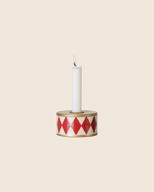 A white candle glows in the PRE-ORDER: Maileg Christmas Candle Holder, Drum - Red/Off White, featuring red diamonds on a cream background with gold trim—perfect for cosy Christmas decor. Estimated arrival mid October.