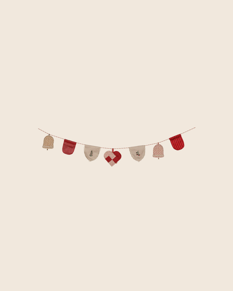 The PRE-ORDER: Maileg Christmas Garland features fabric ornaments—bells, mittens, and a heart—in red, beige, and white patterns on a string, ideal for cozy holiday décor. Estimated arrival mid October.
