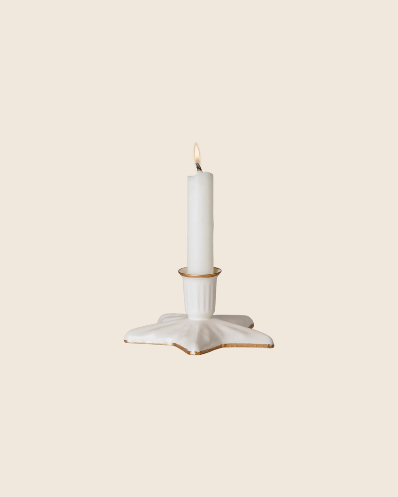 The PRE-ORDER: Maileg Christmas Candle Holder, Star, Small—a white ceramic piece with handpainted golden details—holds a lit white candle and is set against a plain light beige background.