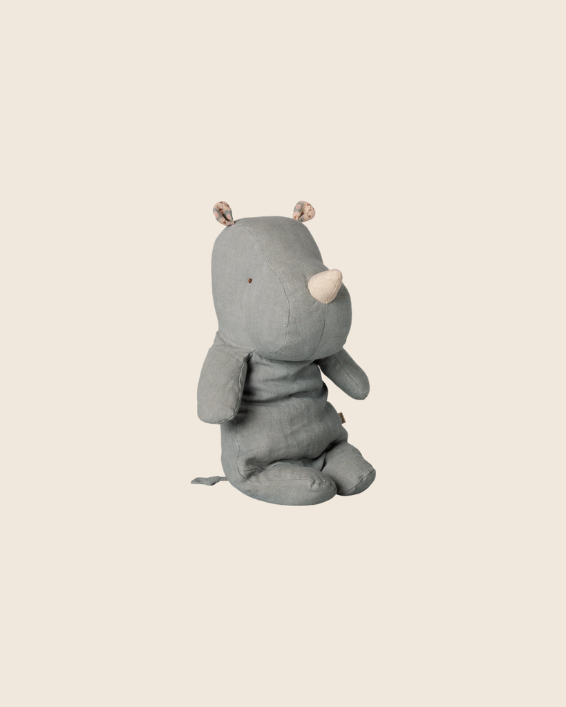 The PRE-ORDER: Maileg Safari Friends, Rhino, Medium - Vintage Blue is a soft toy resembling a rhino with small patterned ears and a beige snout, sitting upright. Estimated arrival is mid November.