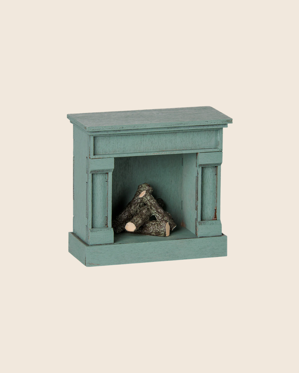 PRE-ORDER the Maileg Fireplace, Mouse - Blue: a small, vintage-finished wooden fireplace with stacked miniature logs, ideal for charming your miniature home. Estimated arrival mid August. Set against a light beige background.