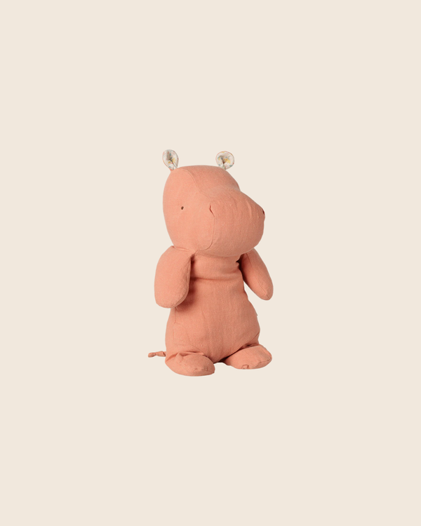 This PRE-ORDER: Maileg Safari Friends Hippo (Medium, Dusty Coral) features simple stitched details and round ears, shown sitting upright on a plain beige background. Estimated arrival early November.