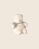 The PRE-ORDER: Maileg Teddy Bear Plush, Mini - Off White, featuring a light blue knitted scarf, sits on a beige background and offers a huggable touch of comfort. Estimated arrival: Early October.