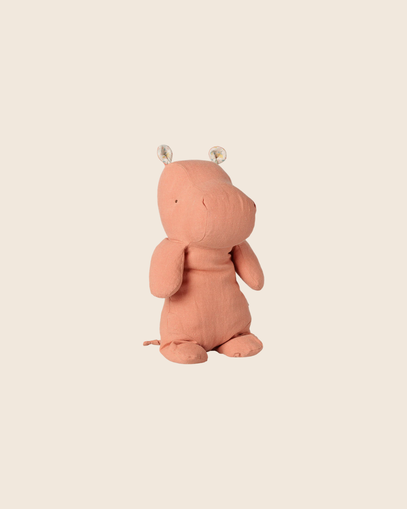 This PRE-ORDER: Maileg Safari Friends Hippo (Medium, Dusty Coral) features simple stitched details and round ears, shown sitting upright on a plain beige background. Estimated arrival early November.