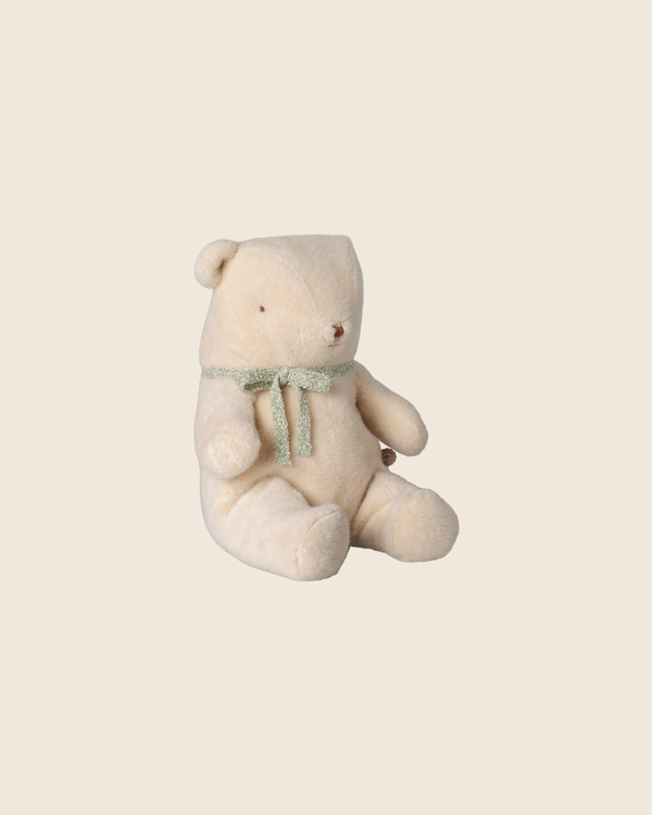The PRE-ORDER: Maileg Teddy Bear Plush, Medium - Off White (arriving early October), features a soft vintage look and sits upright with a green ribbon around its neck against a plain beige background.