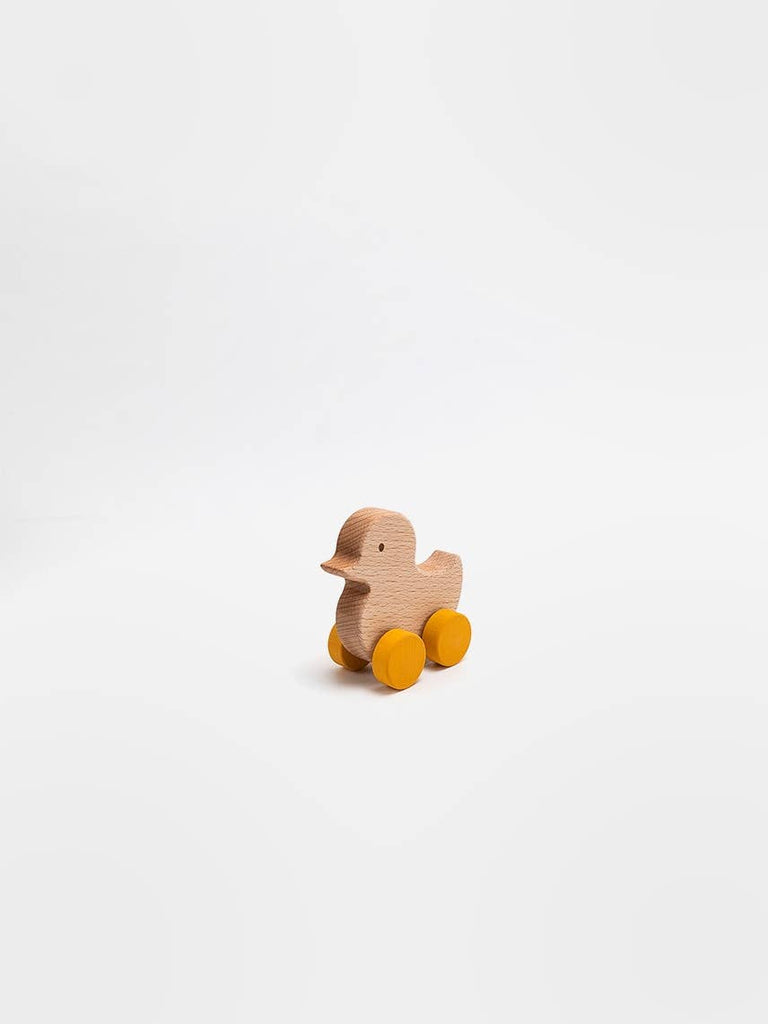 The Sabo Concept Rolling Duck - Yellow, an heirloom-quality wooden toy with yellow wheels, is centered on a plain white background.