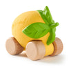 Lou The Lemon Baby Car features textured yellow skin and green leaves, mounted on four wooden wheels for eco-friendly, sensory-rich play.