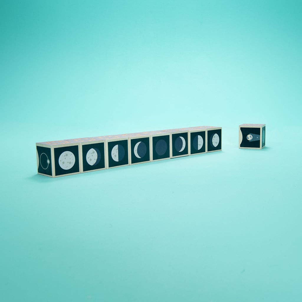 Uncle Goose Moon Phase Blocks are displayed in a row on a light blue background, with one block set apart from the others on the right to show different phases of the moon.