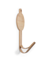 The Coat Hanger - T-Rex Dino features a smooth, light bamboo finish with a circular base, curved hook design, and a small hole at the top for hanging. Mounted on a white wall, it's both functional and stylish.
