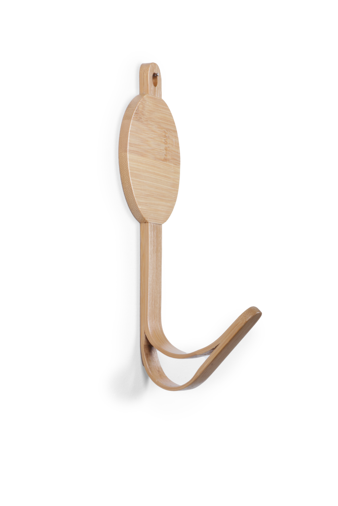 The Coat Hanger - Triceratops Dino features a circular base, two gently curved arms, and a light-colored bamboo hook, all mounted on a white background.