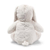 The Steiff Hoppie Bunny Stuffed Animal is a fluffy, light-colored plush, shown from the back sitting upright, with long drooping ears and a small round tail at the bottom.