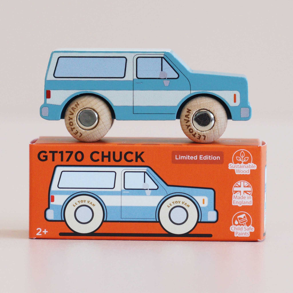 The No. 31 GT170 Chuck | Made in England, a blue wooden SUV toy van, sits atop its orange box adorned with an illustration of the van and labels highlighting sustainable wood, made in England, and child-safe paints—making it perfect for off-road journeys and adventure toy collections.