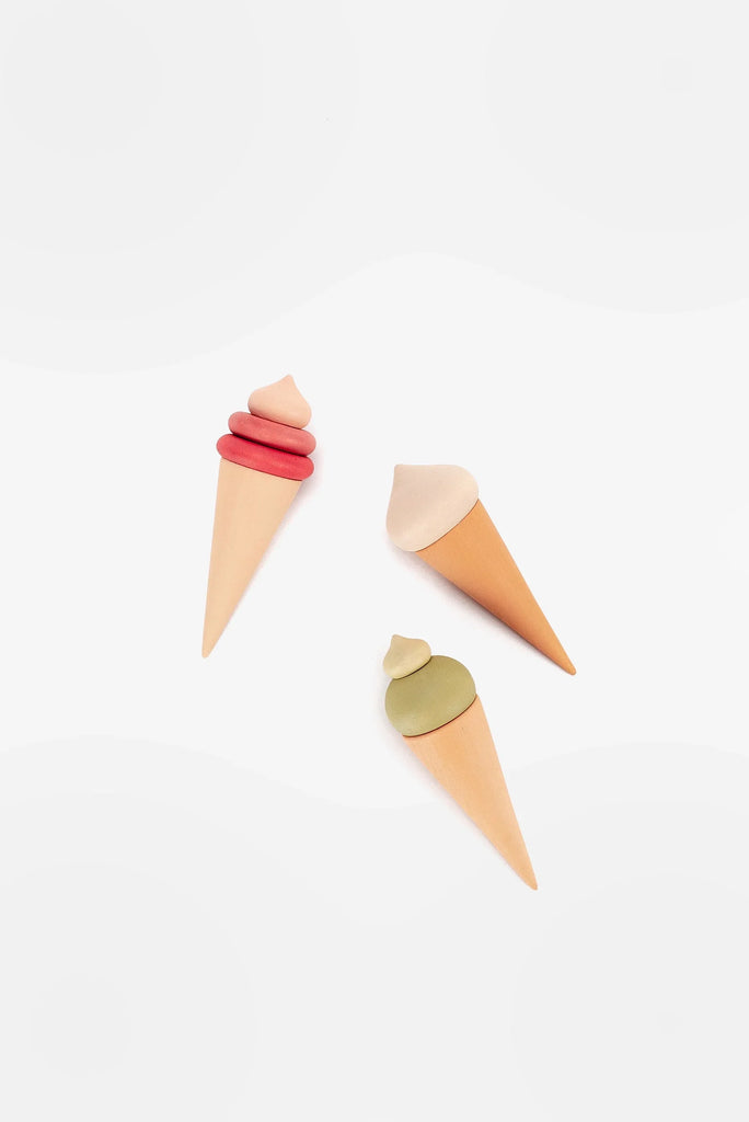 Four Handmade Ice Cream Cones styled as cones in pastel colors, creatively arranged on a white background.
