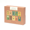 A peach-colored box labeled "Memory Game - Festival of Flowers" features watercolor illustrations of ten blooms in two rows. The brand name "Roomytown" appears at the bottom, showcasing this delightful memory matching game.