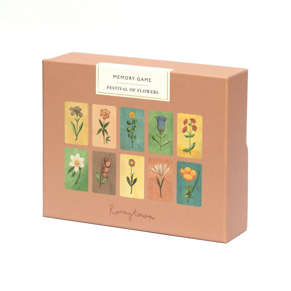 A peach-colored box labeled "Memory Game - Festival of Flowers" features watercolor illustrations of ten blooms in two rows. The brand name "Roomytown" appears at the bottom, showcasing this delightful memory matching game.