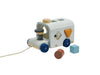 The Sorting Bus - Orchard Series is a wooden pull toy vehicle featuring blue wheels, a pull string, and shape sorting holes—just like the classic PlanToys design. Three colorful shapes—a cylinder, cube, and triangle—come with this engaging sorter for hours of learning fun.