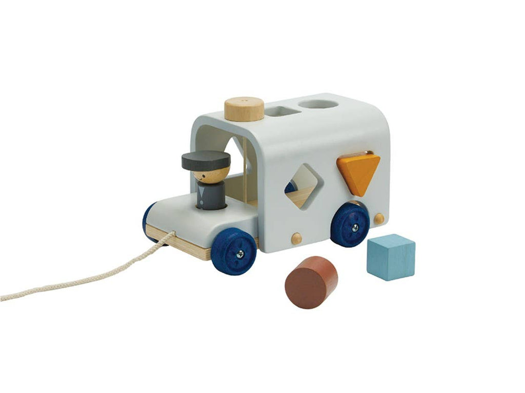 The Sorting Bus - Orchard Series is a wooden pull toy vehicle featuring blue wheels, a pull string, and shape sorting holes—just like the classic PlanToys design. Three colorful shapes—a cylinder, cube, and triangle—come with this engaging sorter for hours of learning fun.
