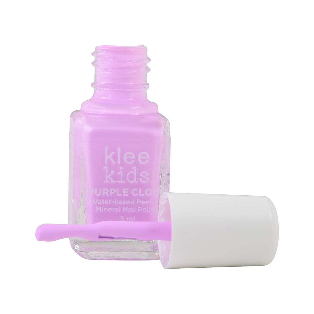 An open bottle of pastel purple Klee Naturals Deluxe Makeup Kit - Unicorn Cloud Fairy non-toxic nail polish with a white cap and applicator brush lying in front.