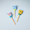 Three Garden Seed Pops (Single)—labeled "Strawberry," "Sweet Basil," and "Carrot Bunch"—rest on a light gray surface. Each features a colorful, family-friendly design with a wooden stick marked "Plant Me!"—ideal as a vegetable garden starter.