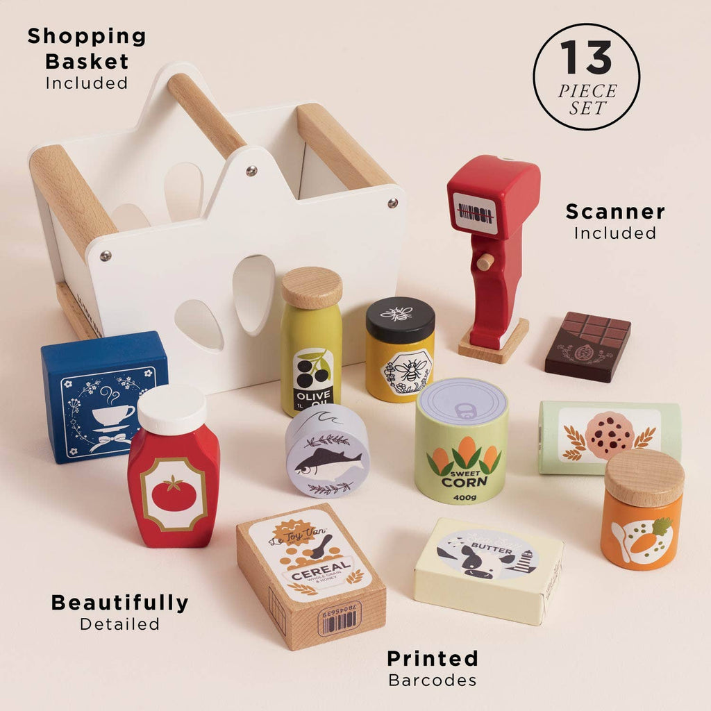 The Groceries Set & Scanner is a 13-piece FSC-certified wooden playset with a white-and-wood shopping basket, red scanner, and colorful pretend boxes, jars, and cans featuring printed barcodes for imaginative play.