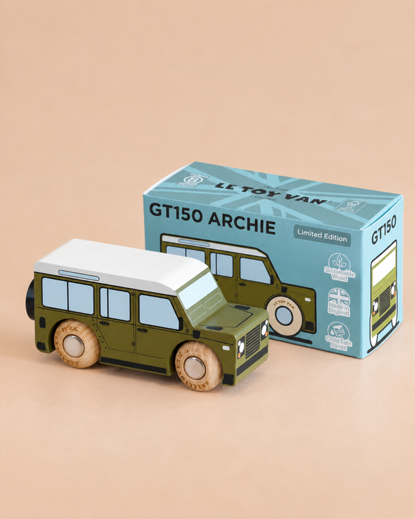 A green and white classic wooden toy car stands beside its blue box, labeled “No. 27 GT150 Archie | Made in England,” which displays playful illustrations, limited edition markings, and promises hours of imaginative play.