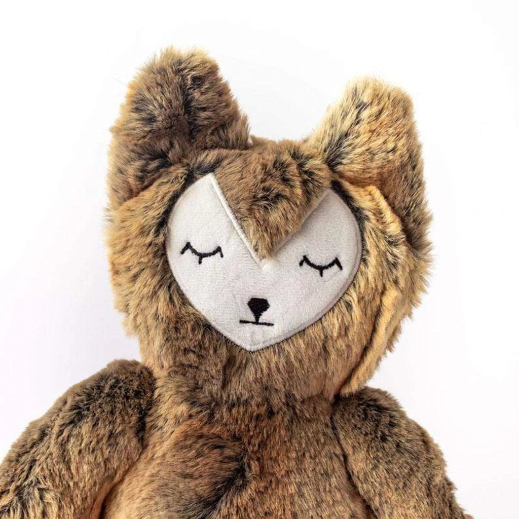 A plush toy resembling a Slumberkins Fox Kin with a white heart-shaped face and closed eyes, featuring large ears and a soft furry texture made from hypoallergenic fiberfill, set against a plain light background