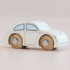 The No. 9 GT55 Betty | Made in England is a small, classic white wooden car featuring simple details, a rounded shape, and natural wooden wheels—perfect for nostalgic toy collections or inspiring imaginative play when displayed on a light surface.