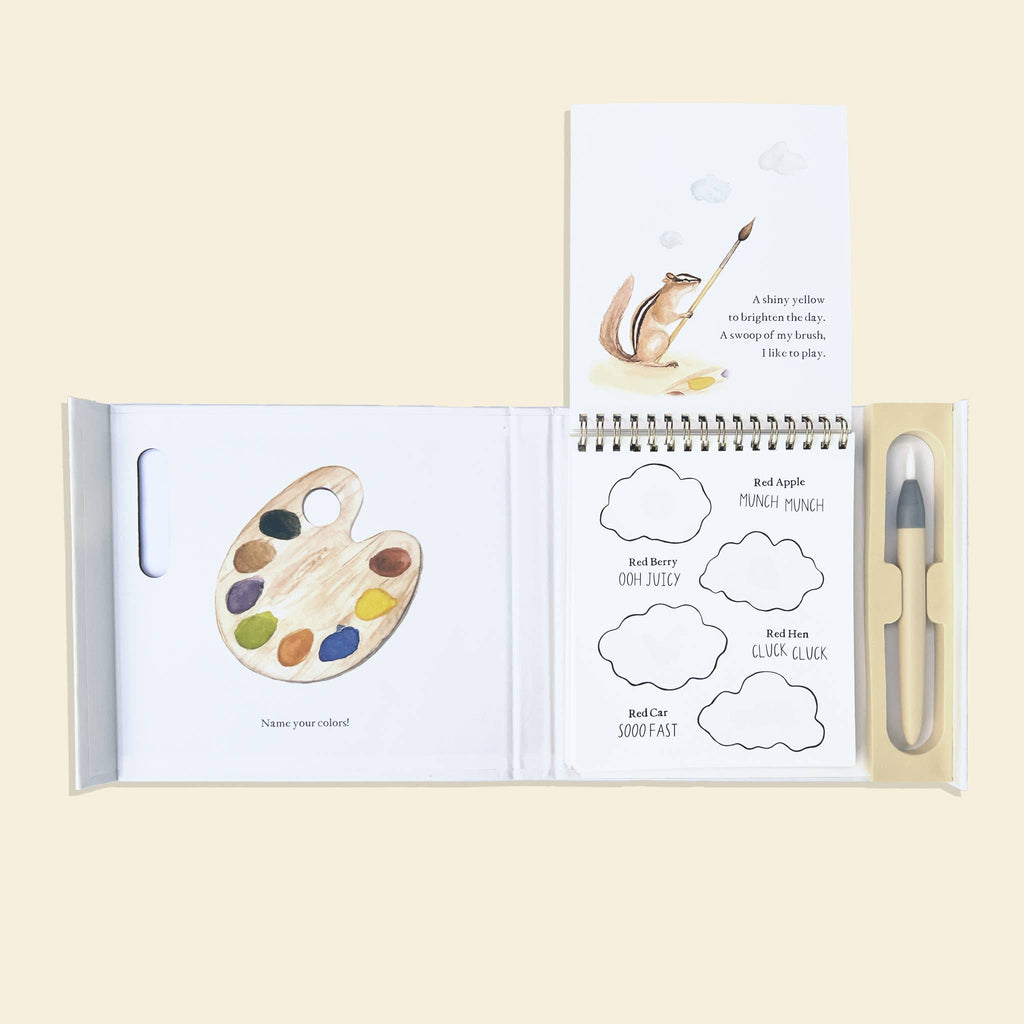 Wishy Washy (Water Reveal Edition) is an open reusable activity book featuring a paint palette illustration, spiral notepad with shapes, a chipmunk storybook, and water brush pen—perfectly arranged for early learning fun.