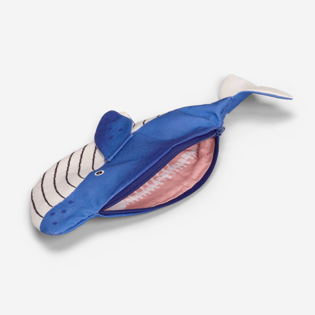 The Minke Whale Pencil Case is a small, handcrafted pouch from Spain, shaped like a blue whale with a zippered side that opens to reveal a pink, tooth-patterned interior resembling the inside of a mouth.