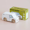 A small classic wooden toy van with wooden wheels sits beside its green and yellow box labeled “No. 32 GT175 Frank | Made in England,” which features an illustration of the white wooden van—perfect for imaginative play.